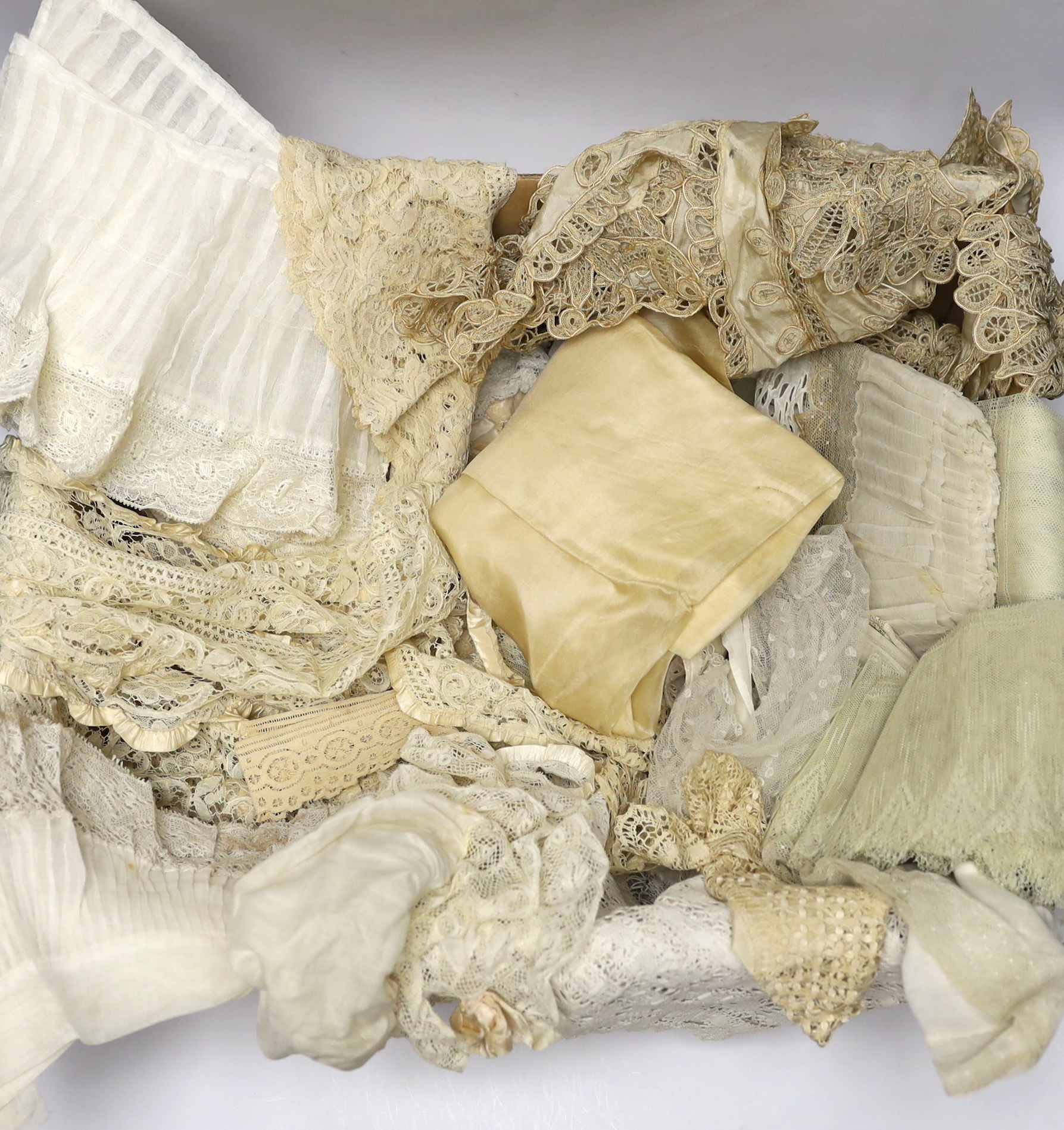 Mixed lace trimmings: a collection of Honiton bobbin lace trimming, a silk tape lace collar, various fine pleated gauze and lace edged trimmings, a silk skirt flounce, etc. A useful collection for making lace garments